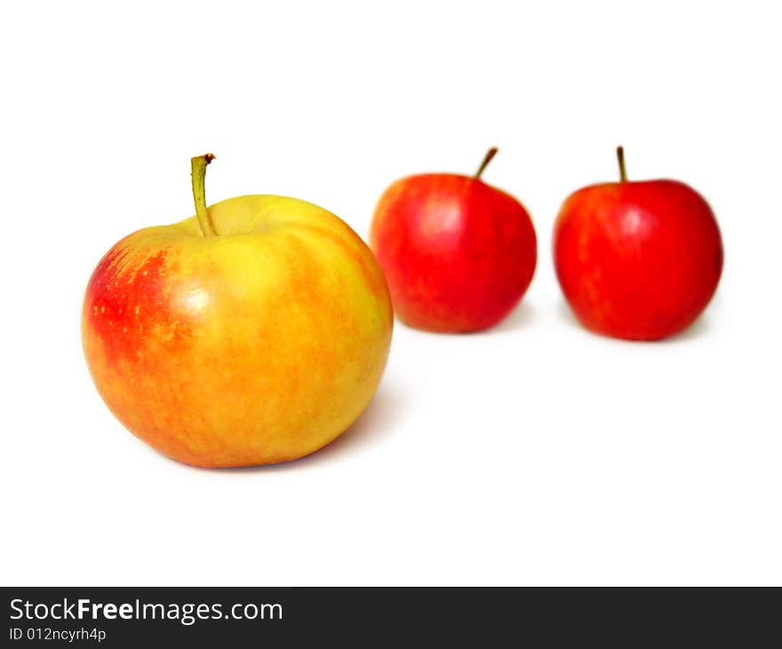 Two red and one yellow apples isolated on white background