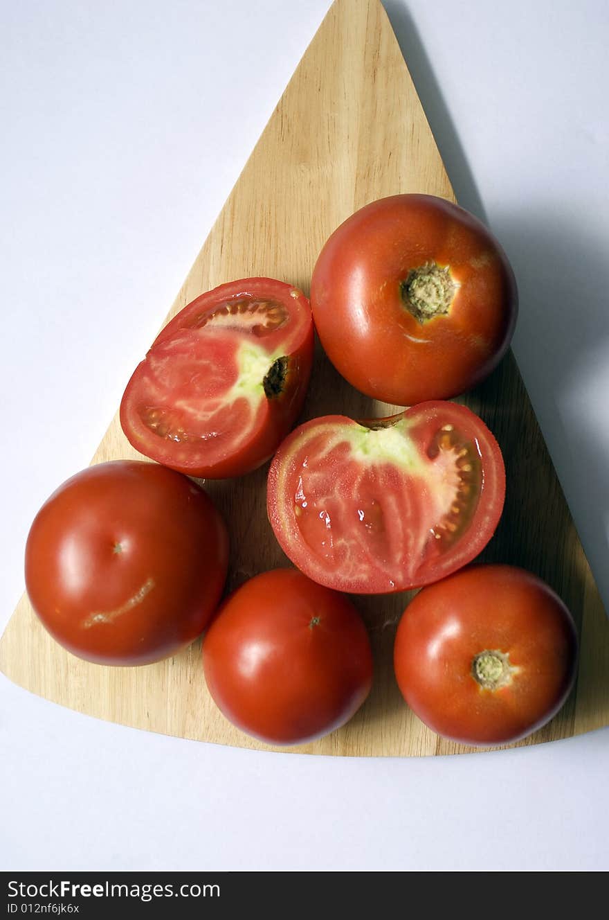 Five tomato on table