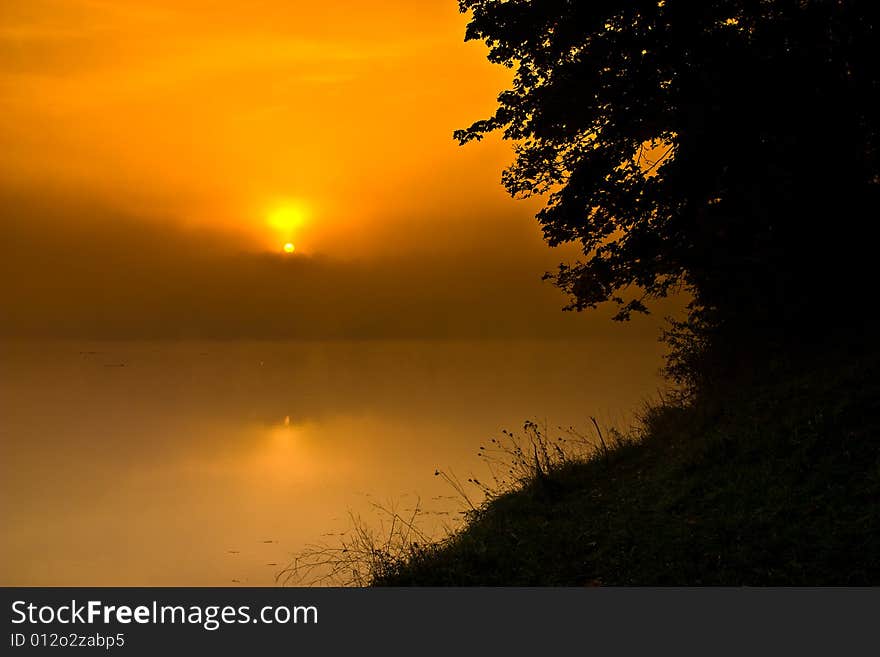 Hazy smoggy morning sunrise shining through. Hazy smoggy morning sunrise shining through