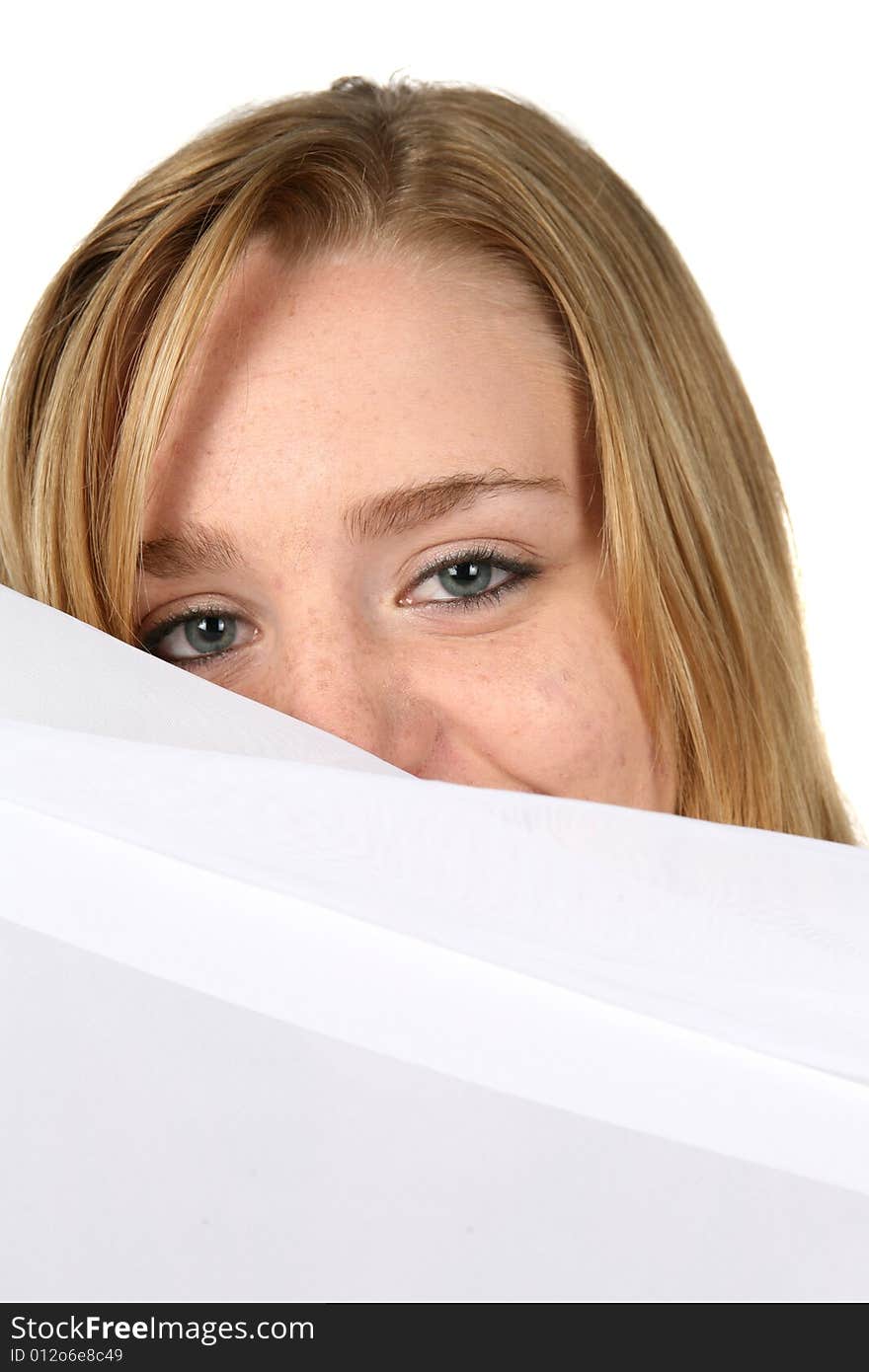 Woman peeking over white pillow. Woman peeking over white pillow