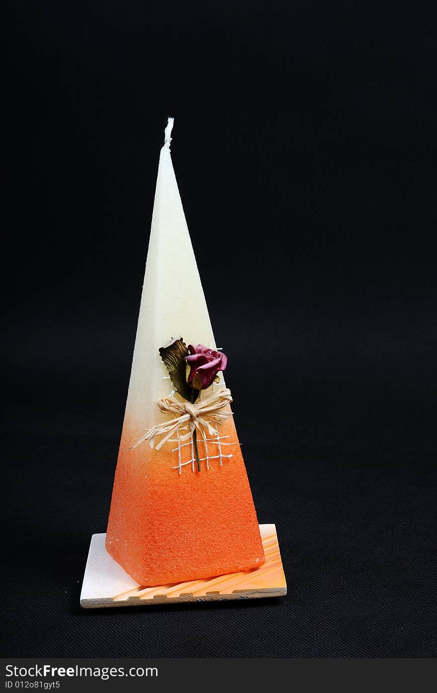 Image of orange candle with rose. Image of orange candle with rose