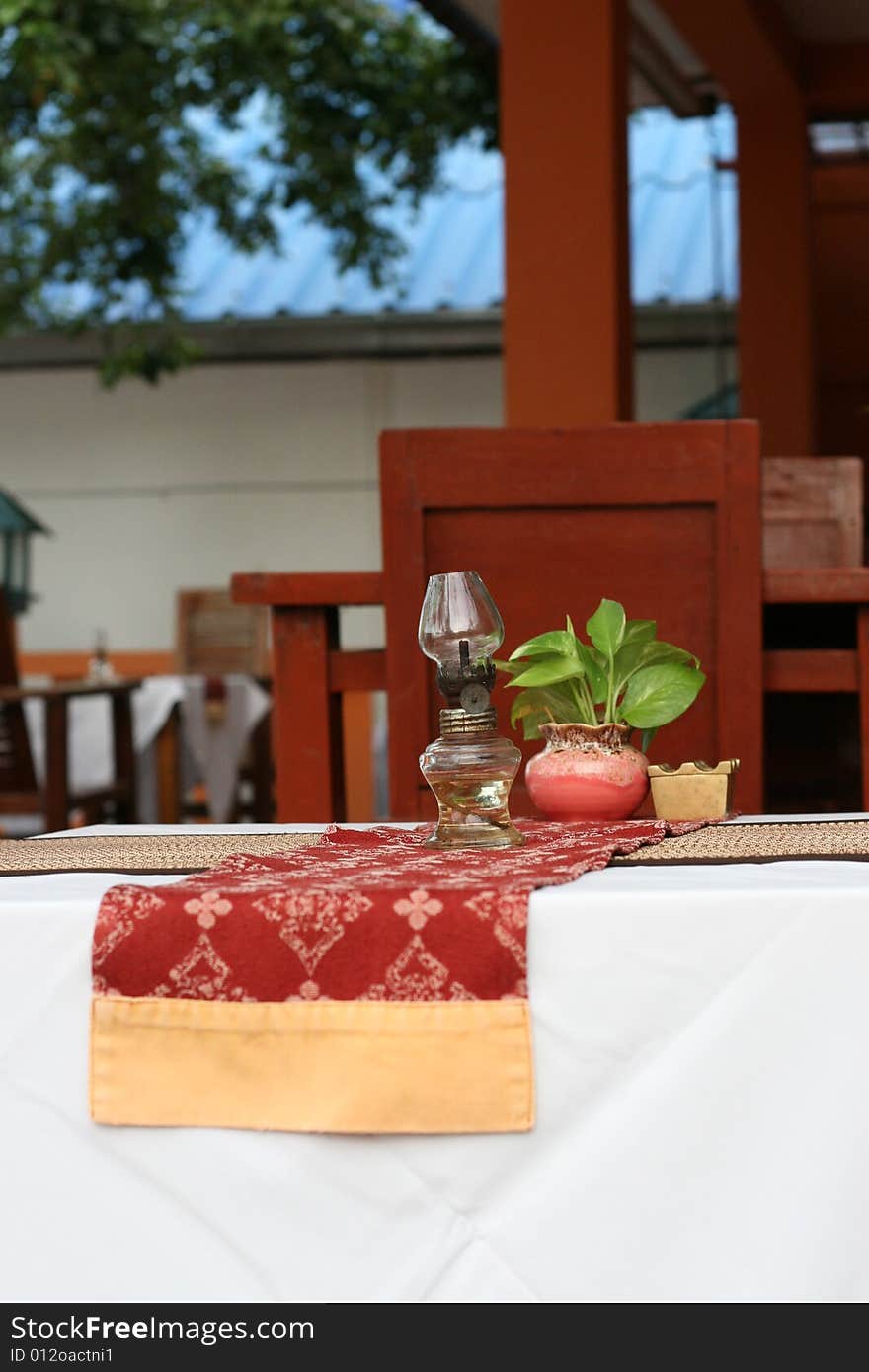 Close-up of a table with a glass lantern. Close-up of a table with a glass lantern.