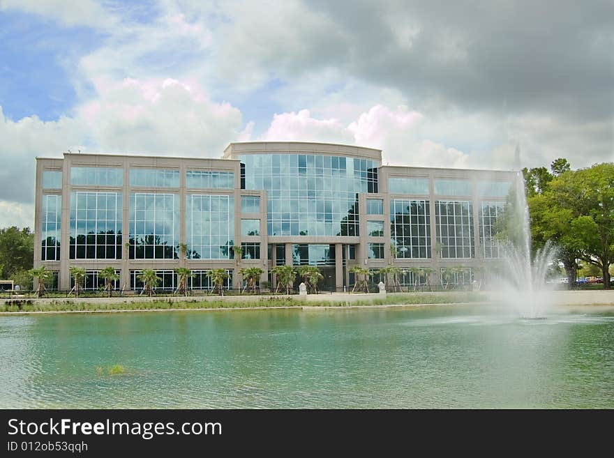 Office building with fountain and dark cloud. Office building with fountain and dark cloud.