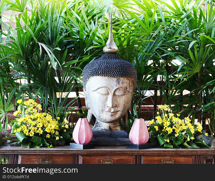 Buddhist sculpture with flowers in Thailand - travel and tourism. Buddhist sculpture with flowers in Thailand - travel and tourism.