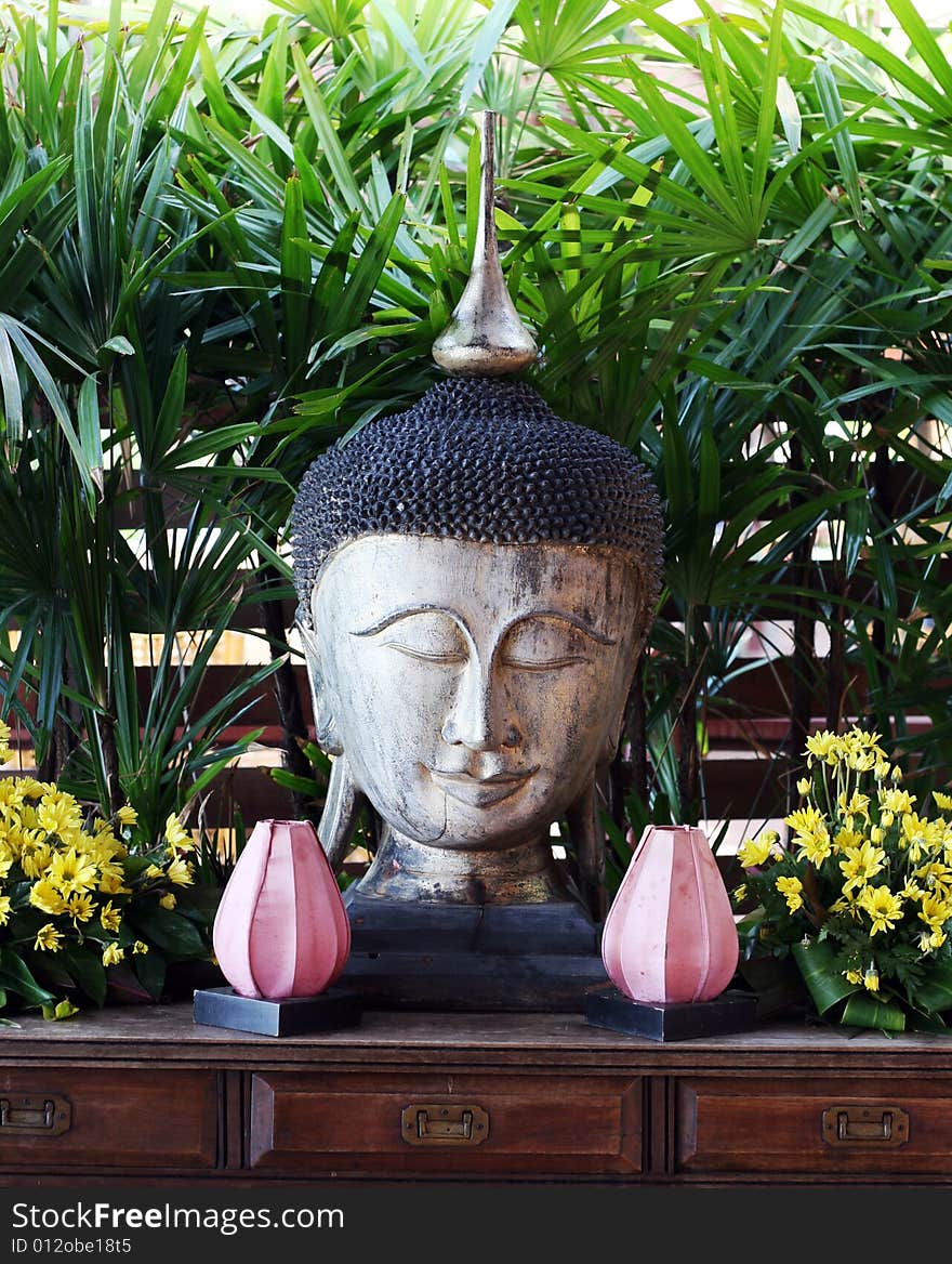 Buddhist sculpture with flowers in Thailand - travel and tourism. Buddhist sculpture with flowers in Thailand - travel and tourism.