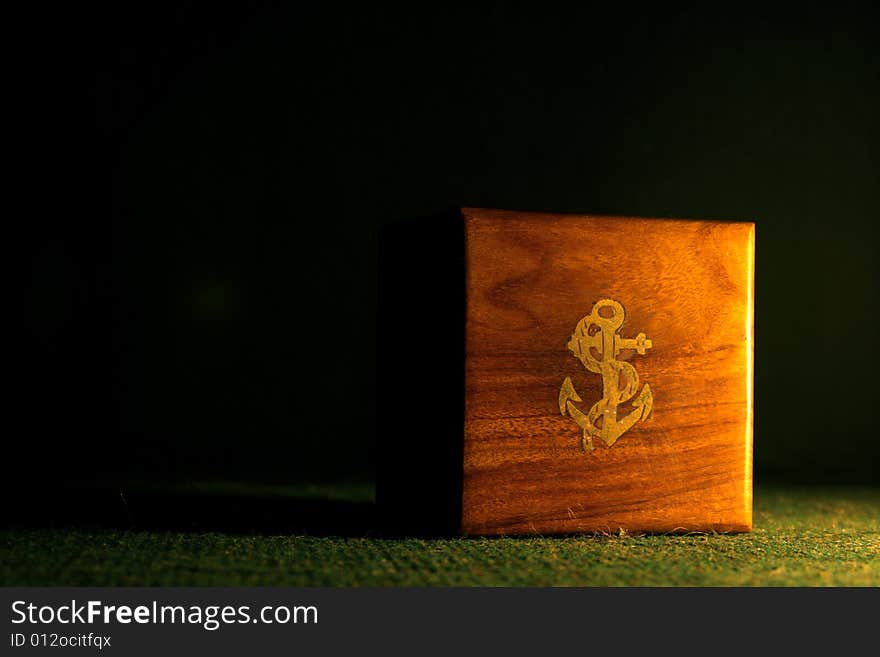 A small wooden box with an anchor sign. A small wooden box with an anchor sign