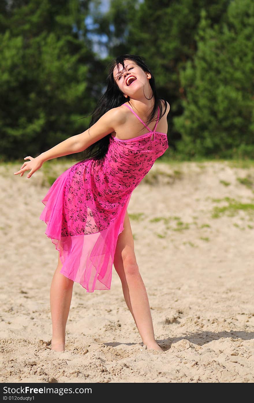 Happy woman dancing on the beach