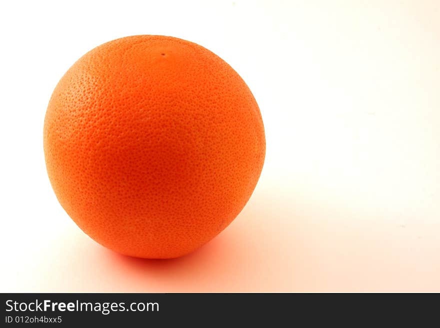 Single grapefruit set against a white backdrop. Single grapefruit set against a white backdrop