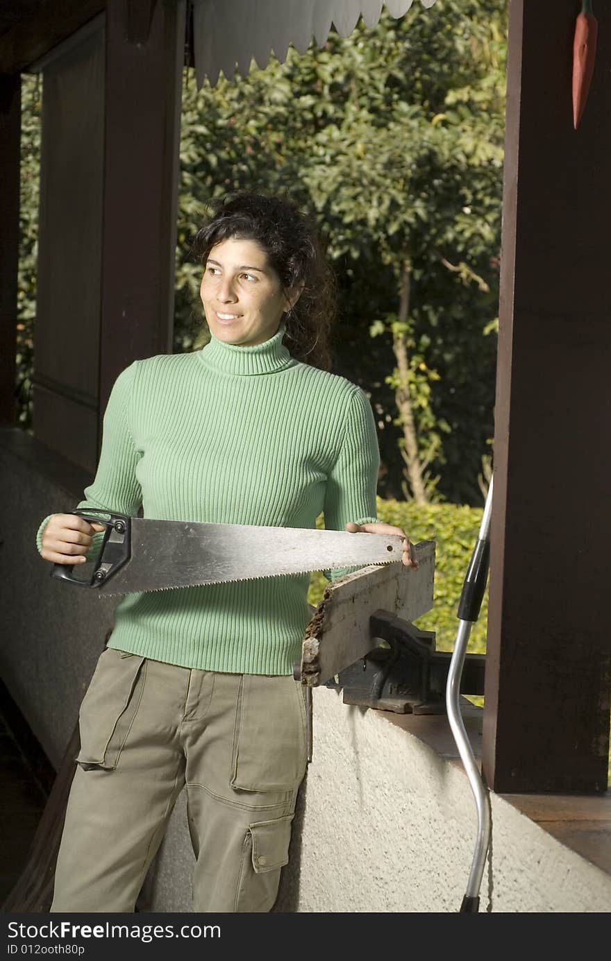 Woman Holding Handsaw - Vertical