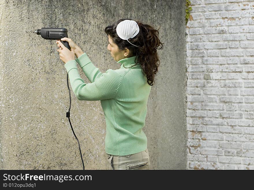 Woman Drills into Wall - Horizontal