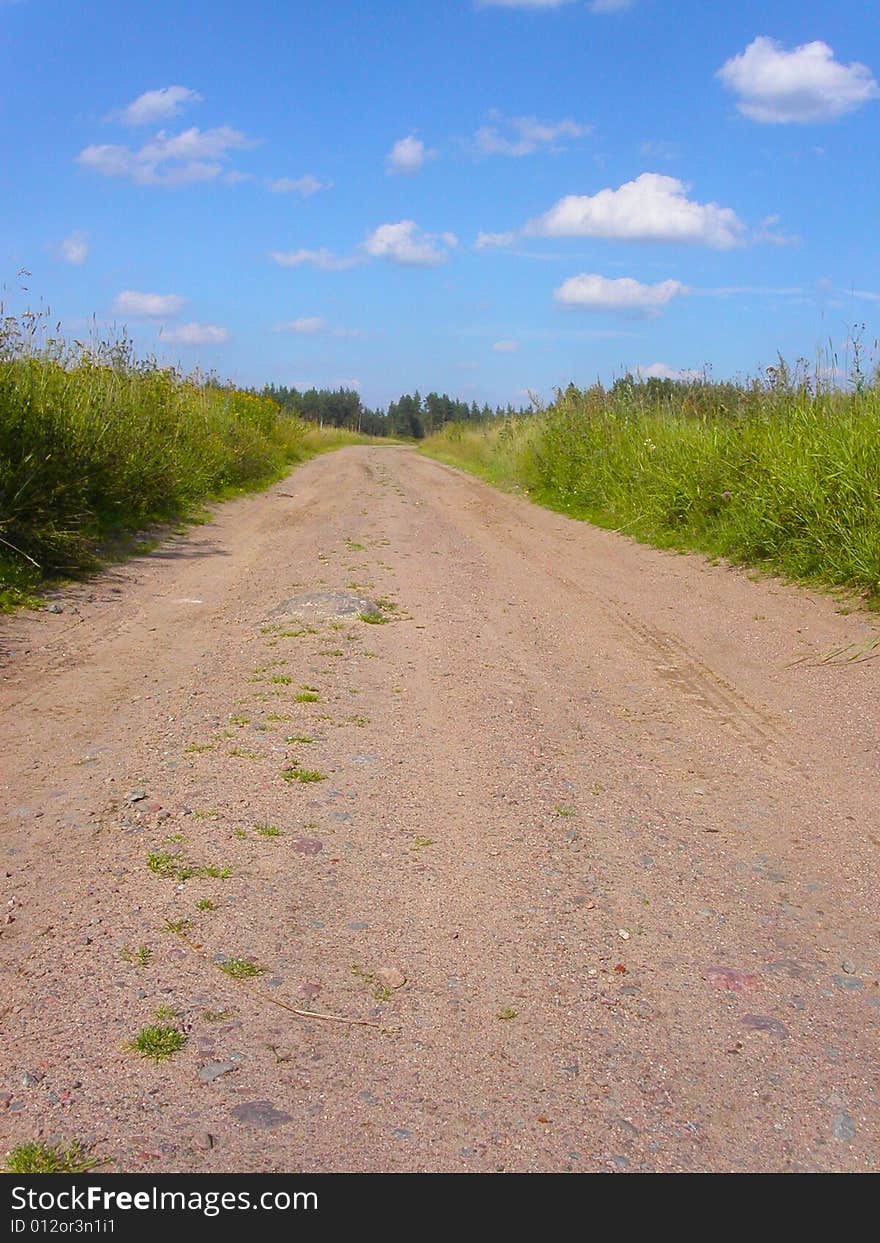 Soil road through a field