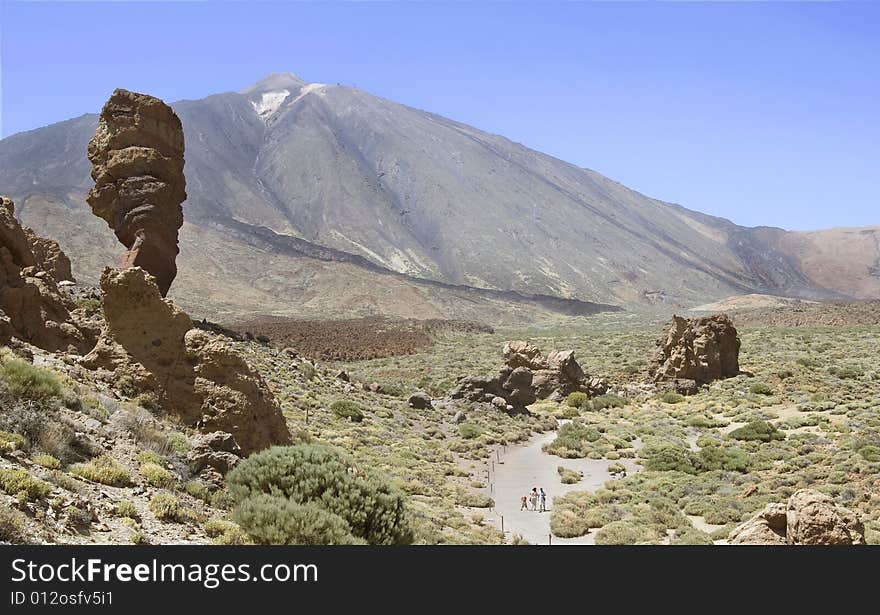 A young family going for a walk at the base of Mount Teide