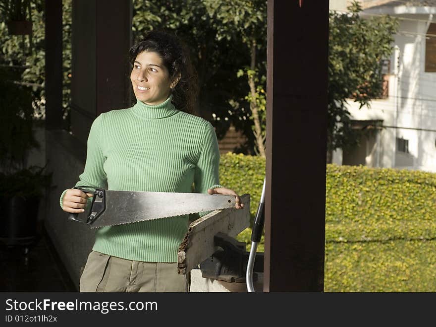 Woman Holding Handsaw - Horizontal