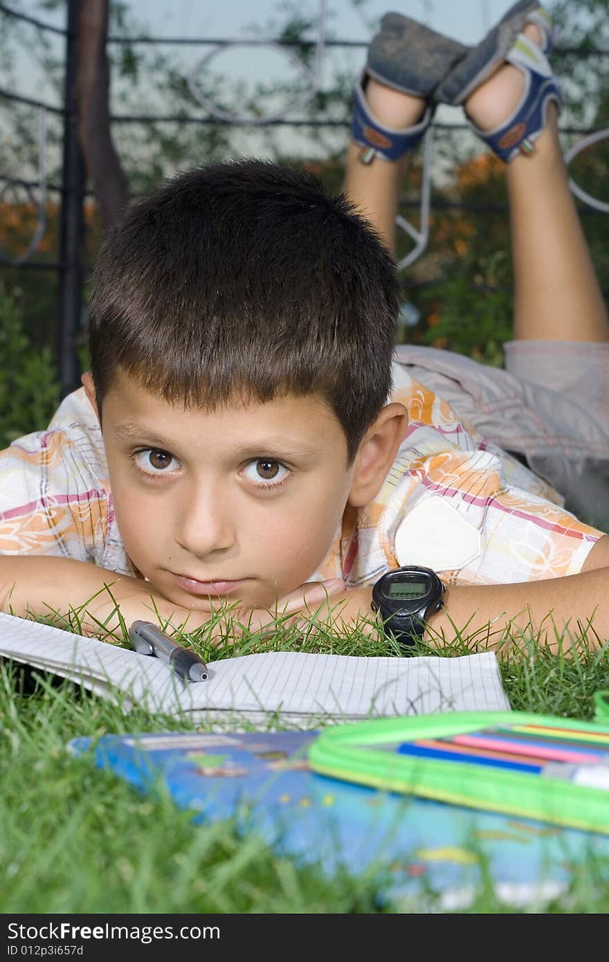 Boy doing  home work outdoor