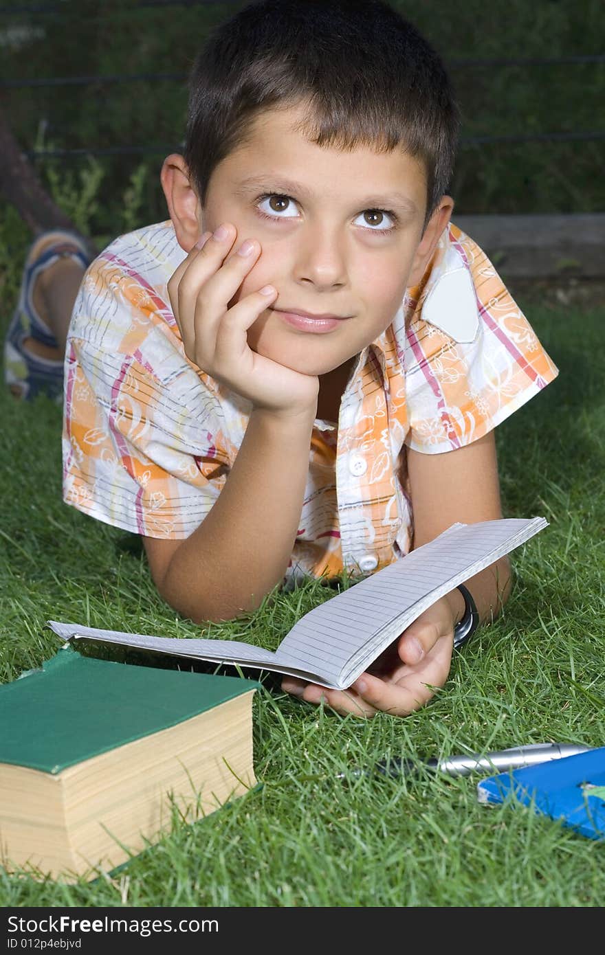 Boy doing  home work outdoor