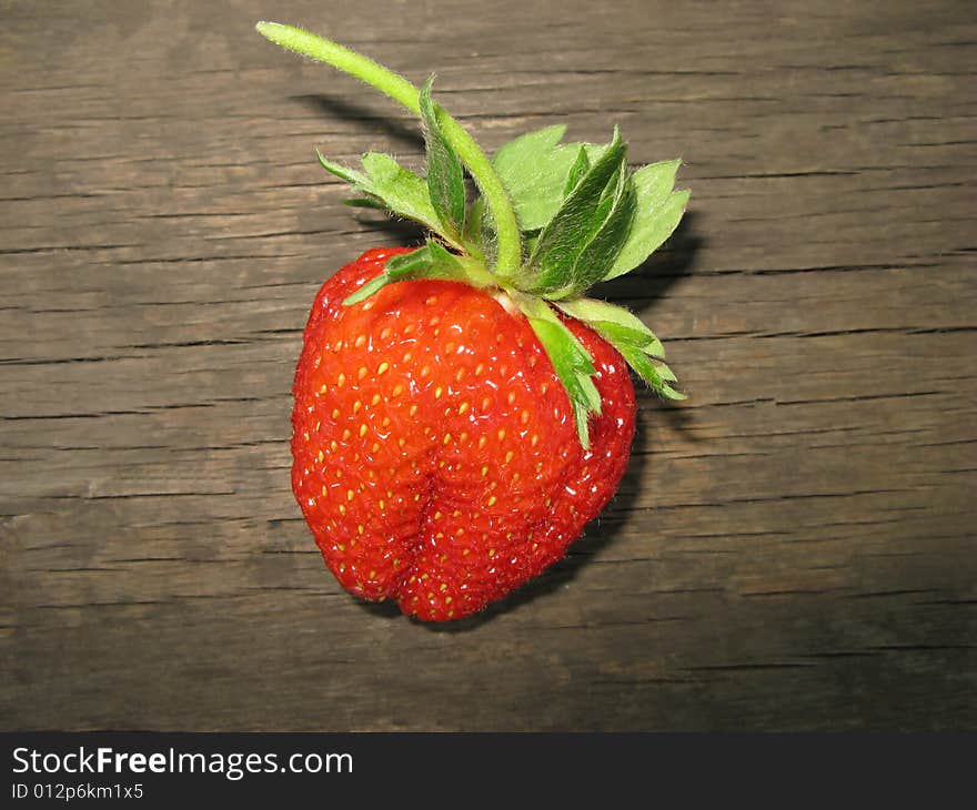 Red color  berry of  strawberry on  surface of  wooden board