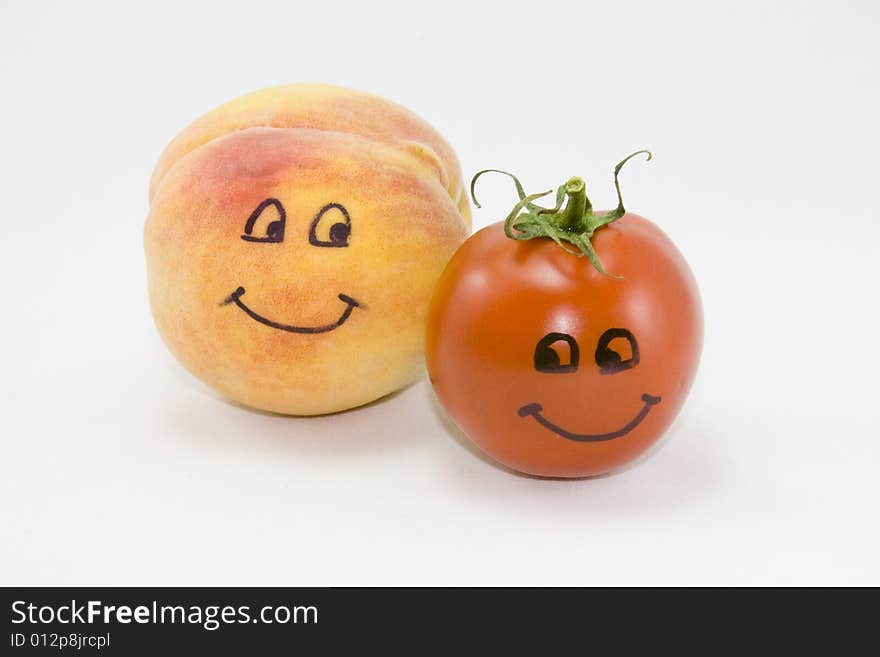 Animated peach and tomato on white background. Eyes and mouth drawn on each fruit and vegetable respectively. Animated peach and tomato on white background. Eyes and mouth drawn on each fruit and vegetable respectively.