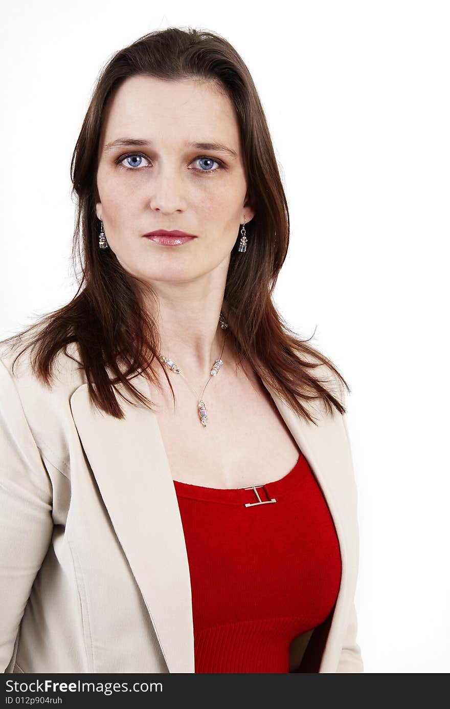 Beautiful brunette businesswoman wearing a beige jacket and a red top. Isolated on white background with copy space. Beautiful brunette businesswoman wearing a beige jacket and a red top. Isolated on white background with copy space