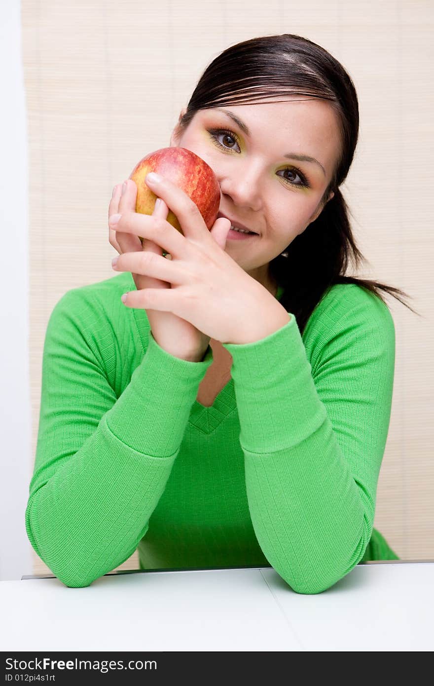 Attractive brunette woman holding apple. Attractive brunette woman holding apple