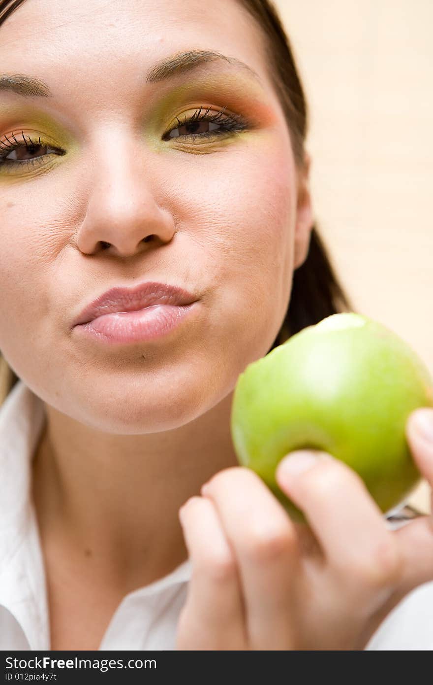 Attractive brunette woman holding apple. Attractive brunette woman holding apple