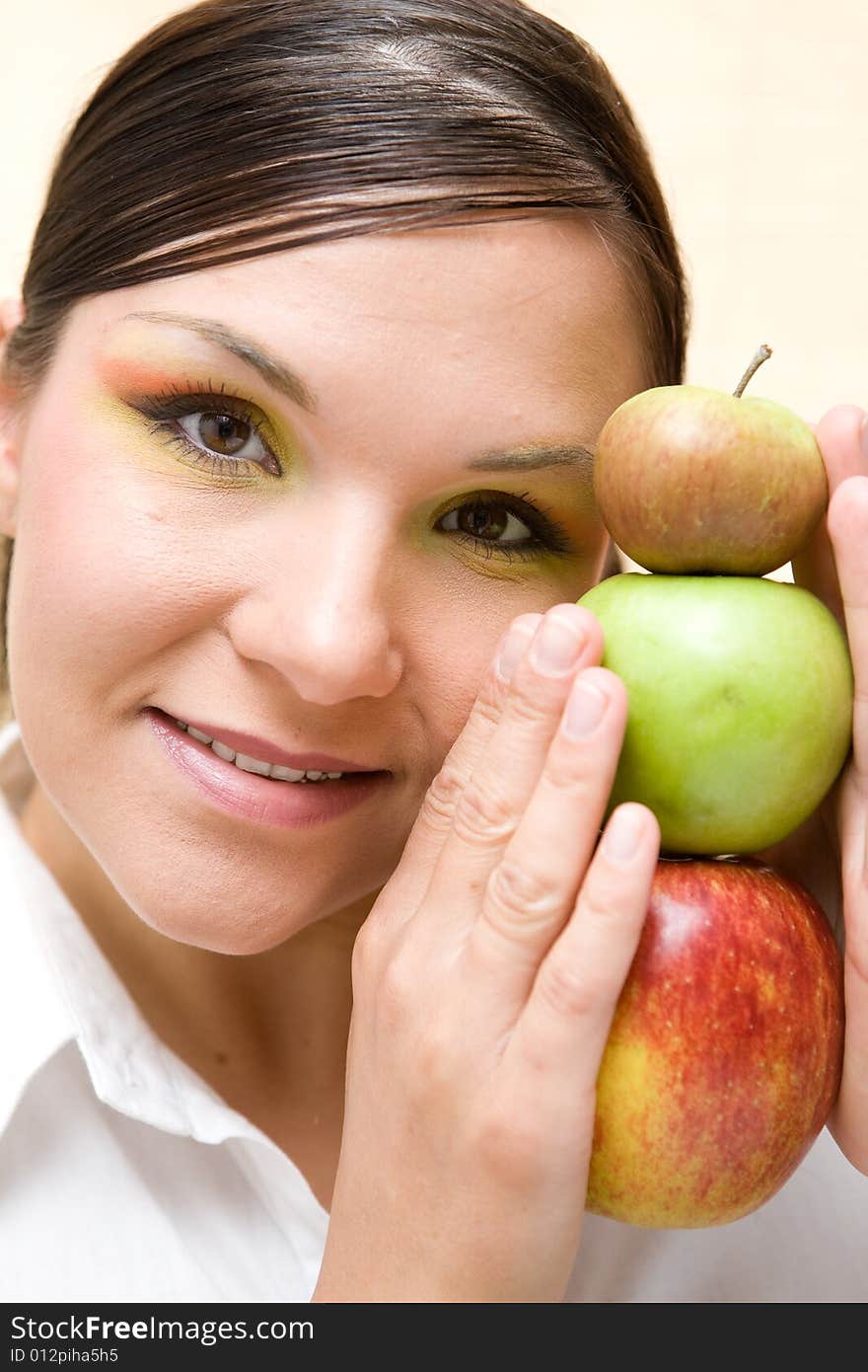 Attractive brunette woman holding apple. Attractive brunette woman holding apple