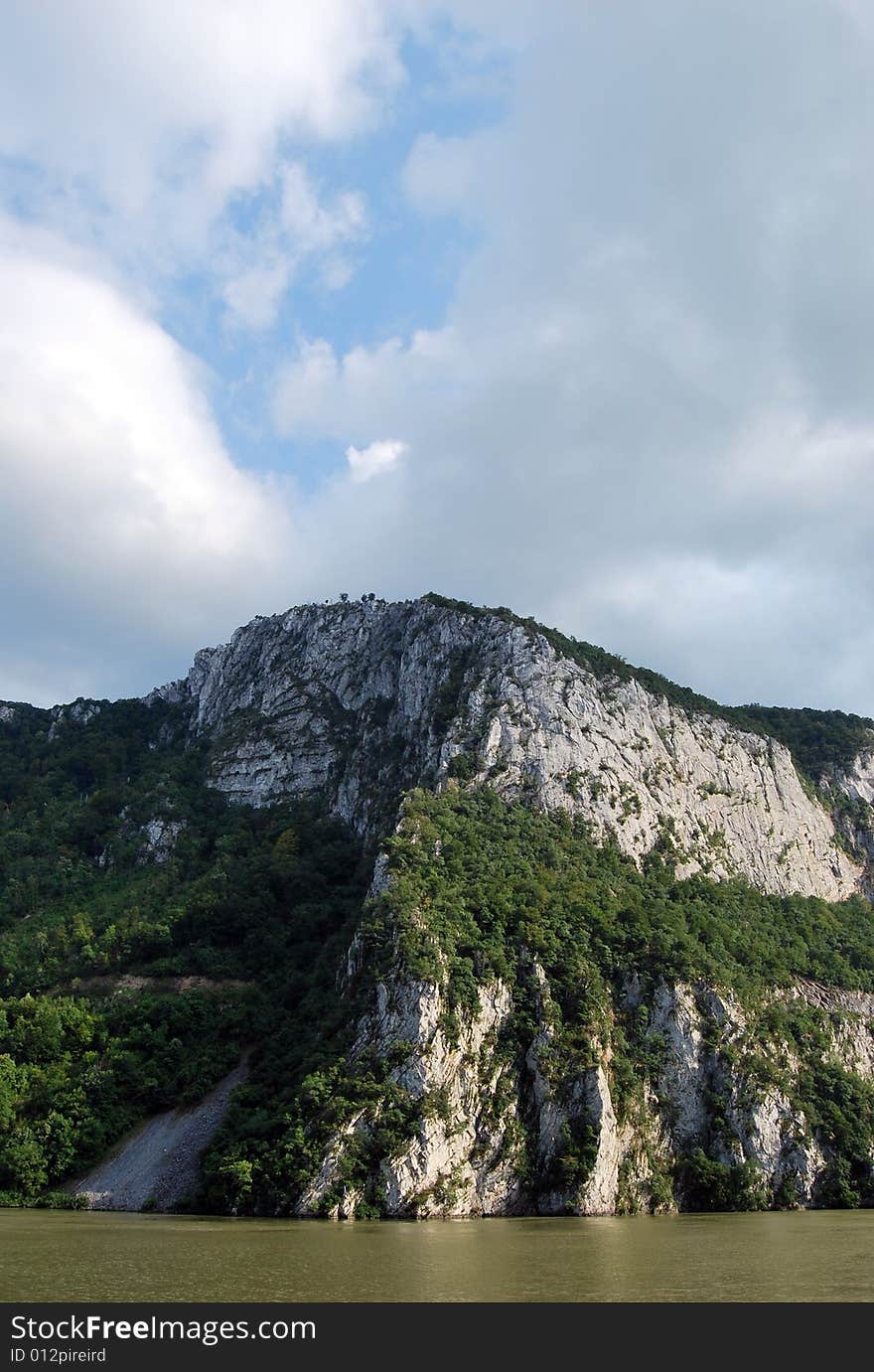 A picture of mountain river with dark clouds