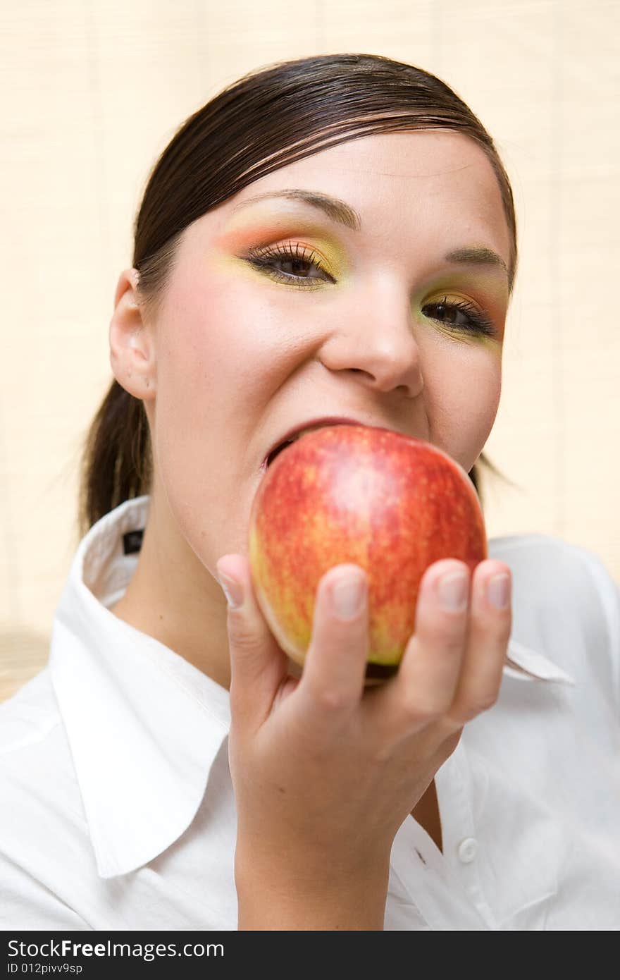 Attractive brunette woman holding apple. Attractive brunette woman holding apple