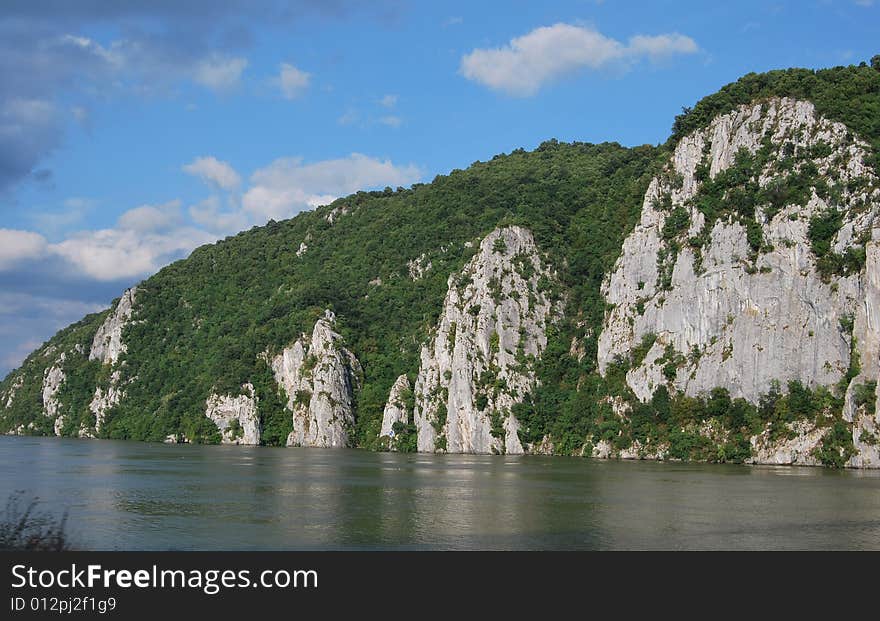 A picture of mountain river with white clouds