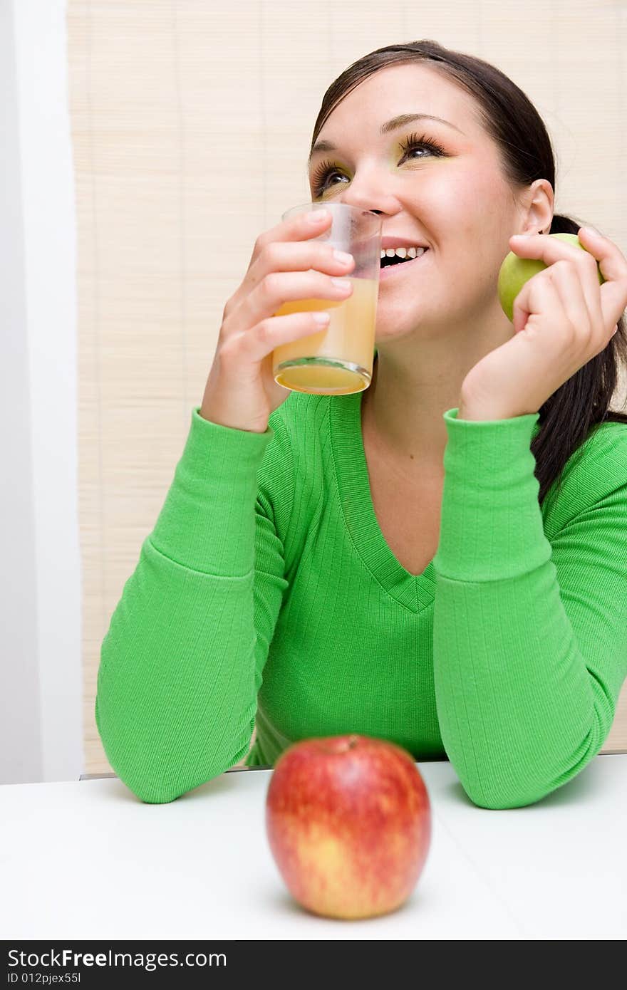 Attractive brunette woman holding apple. Attractive brunette woman holding apple