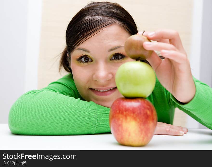 Attractive brunette woman holding apple. Attractive brunette woman holding apple