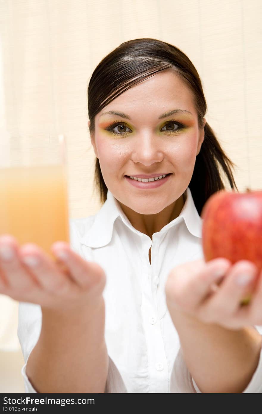 Attractive brunette woman holding apple. Attractive brunette woman holding apple