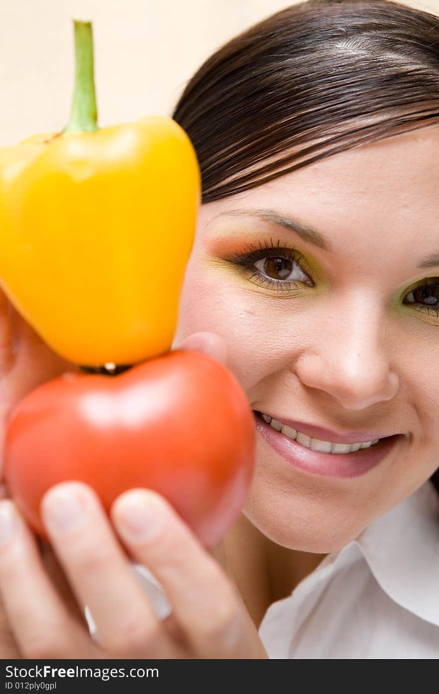 Attractive brunette woman holding vegetable. Attractive brunette woman holding vegetable