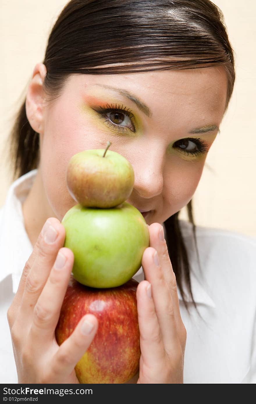 Attractive brunette woman holding apple. Attractive brunette woman holding apple