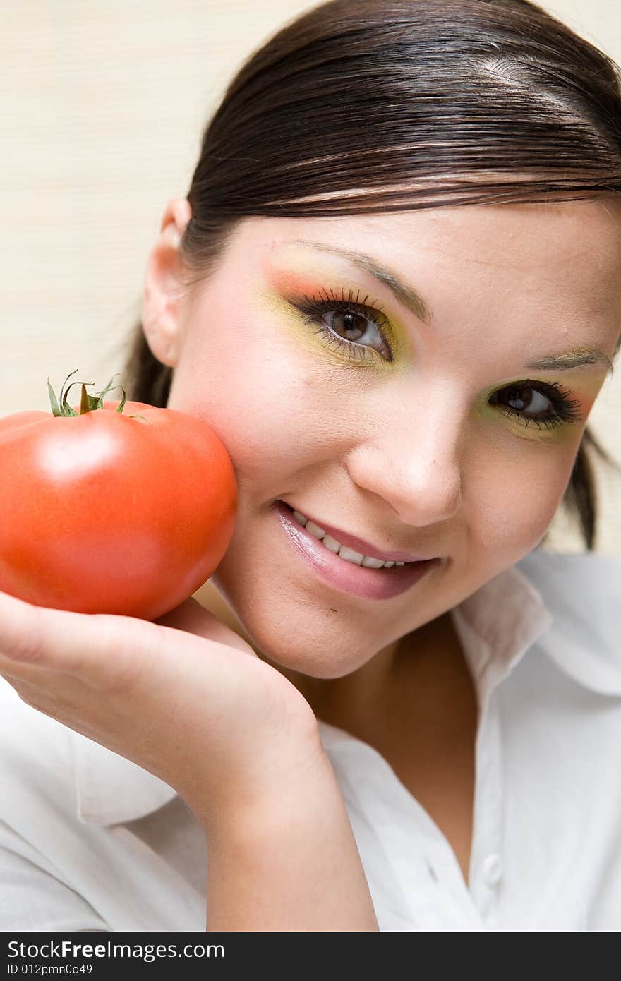 Attractive brunette woman holding vegetable. Attractive brunette woman holding vegetable