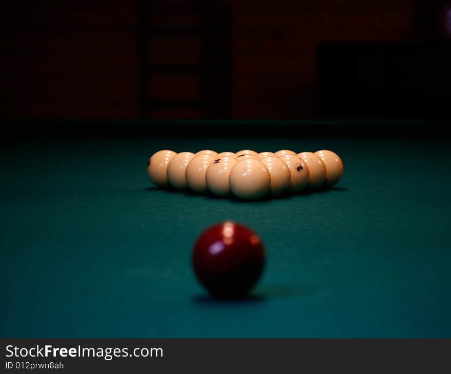 A few pool balls in a billiard table