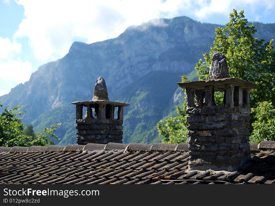 Two chimney pots in a mountain village in Piedmont, Italy. Two chimney pots in a mountain village in Piedmont, Italy.