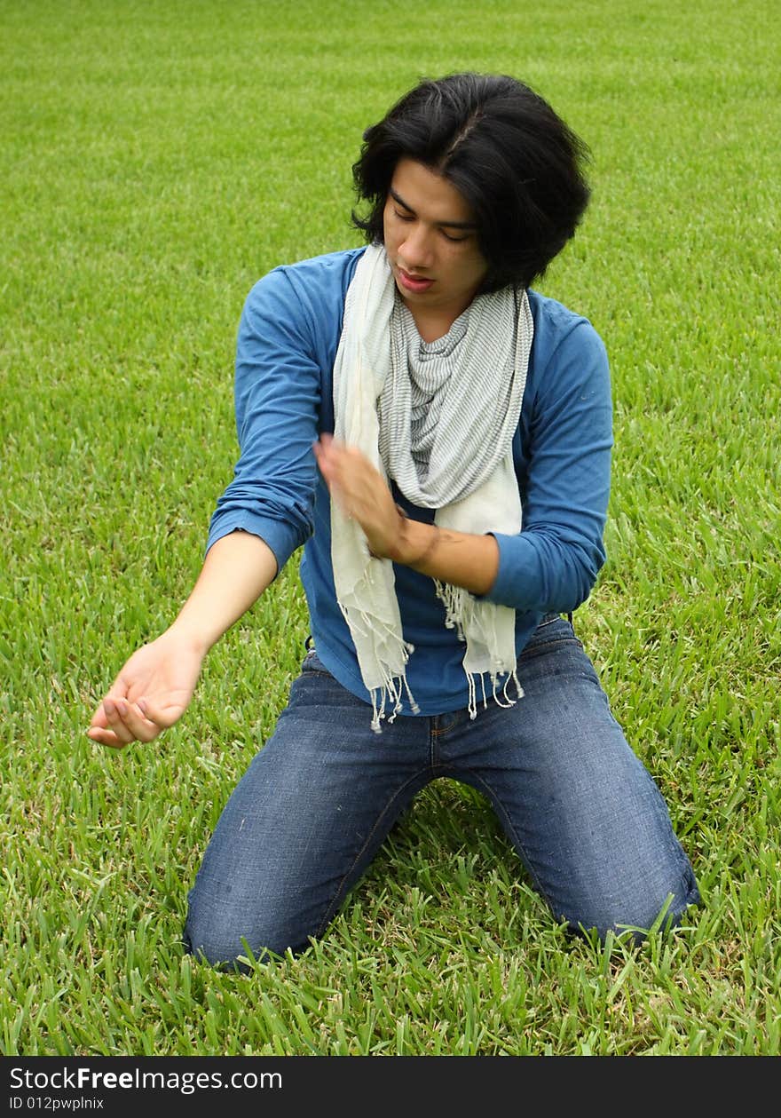 Man brushing off blades of grass from. Man brushing off blades of grass from