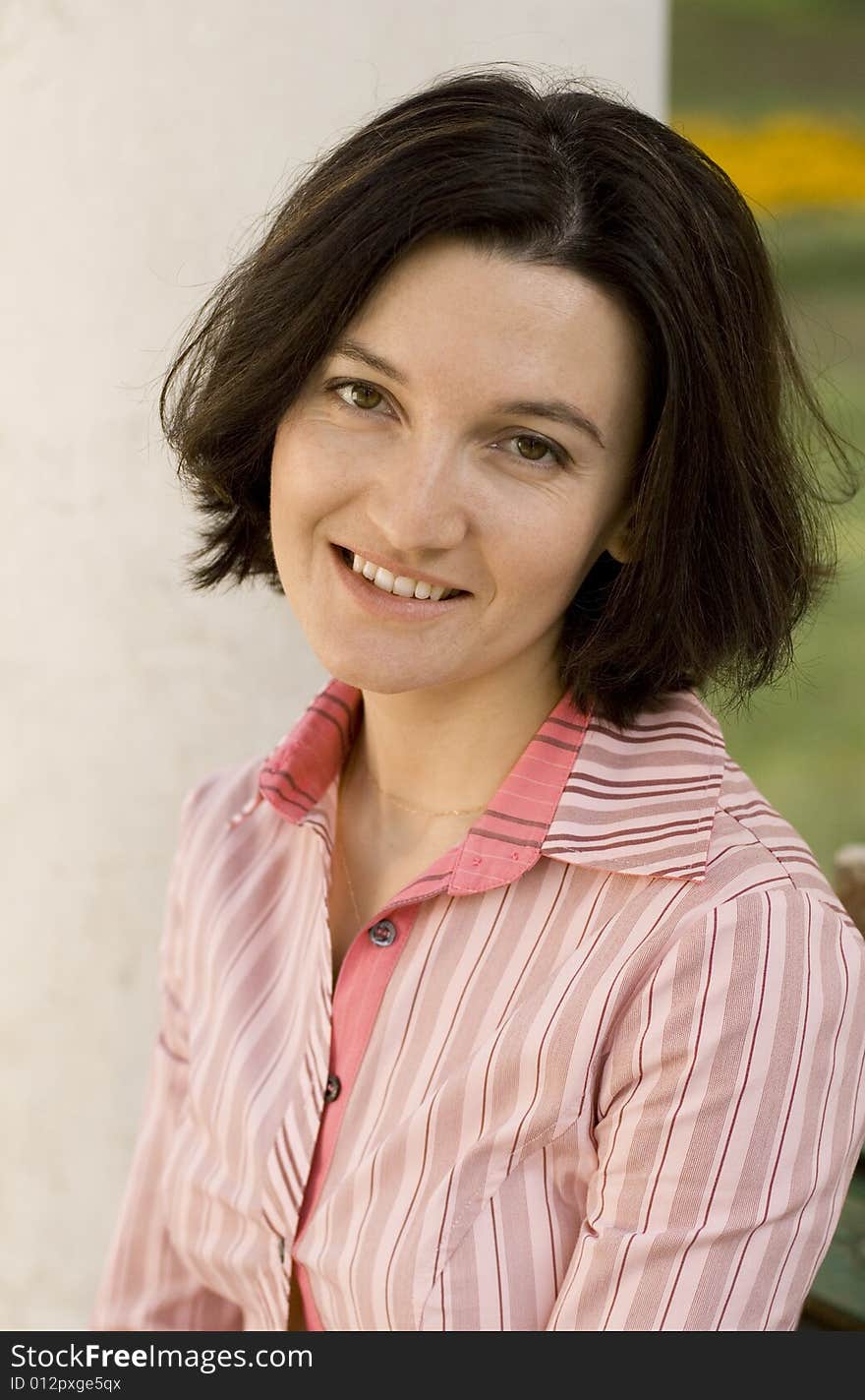 Outdoor portrait of smiling brunet woman