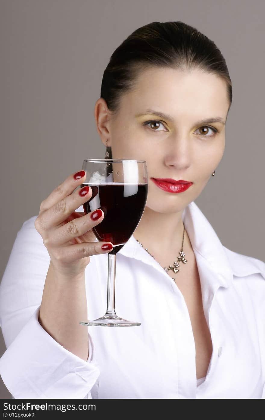 Portrait of beautiful woman with glass red wine