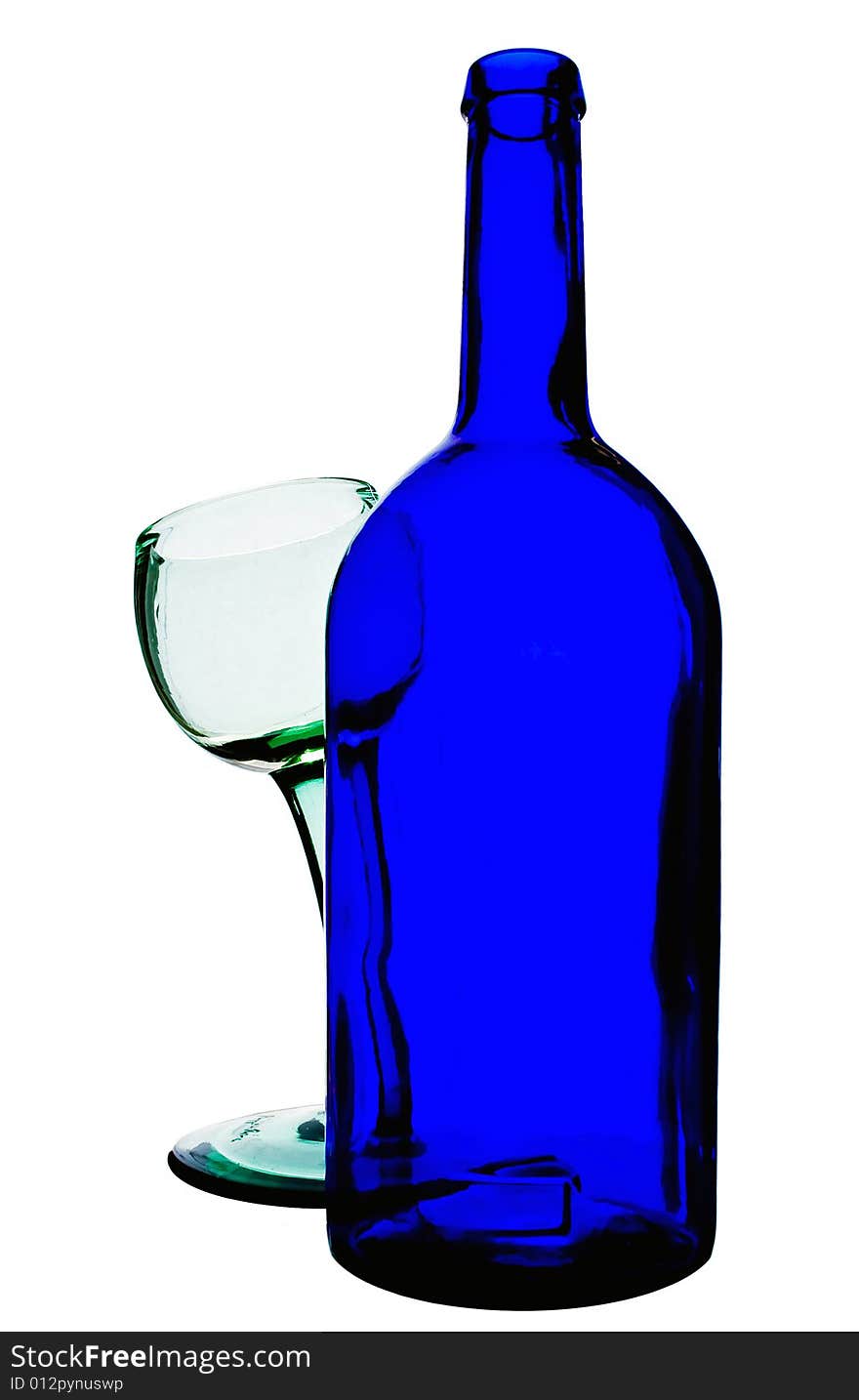 Blue bottle standing before a green glass wich is bent. Blue bottle standing before a green glass wich is bent