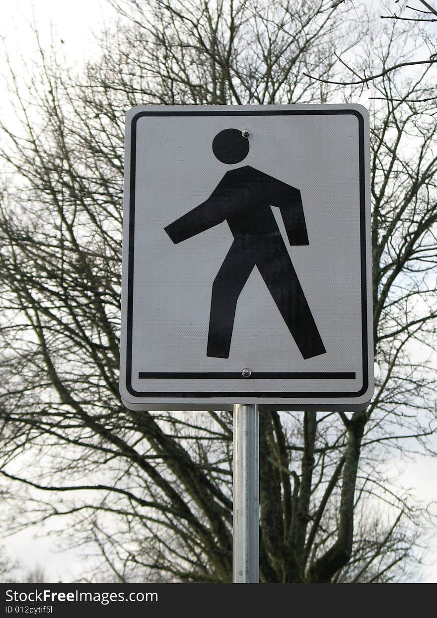 Black and white pedestrian crossing sign