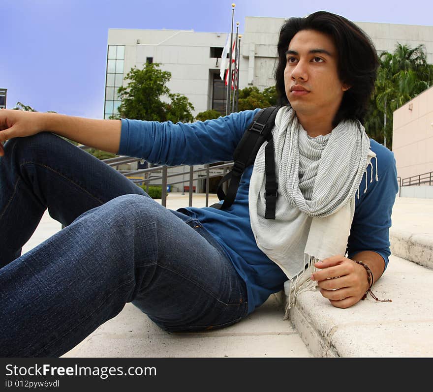 Young male sitting on stairs. Young male sitting on stairs.