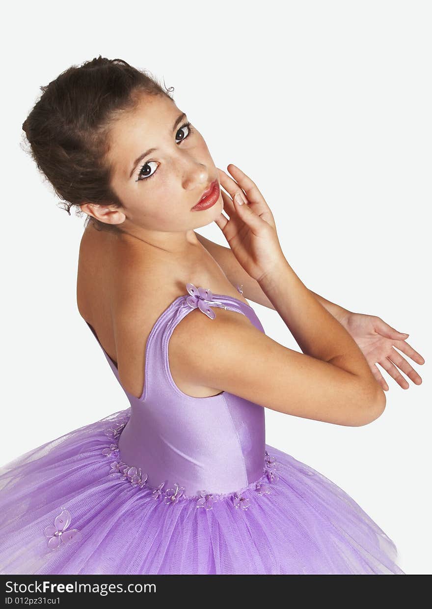 Young beautiful Ballerina with red lips dressed in purple tutu looking sideways in standing position. Young beautiful Ballerina with red lips dressed in purple tutu looking sideways in standing position