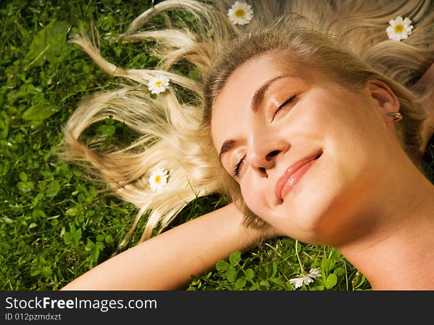 Young woman relaxing on a meadow