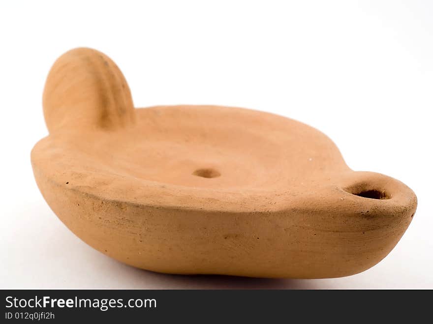 Terracotta oil lamp on white. Terracotta oil lamp on white