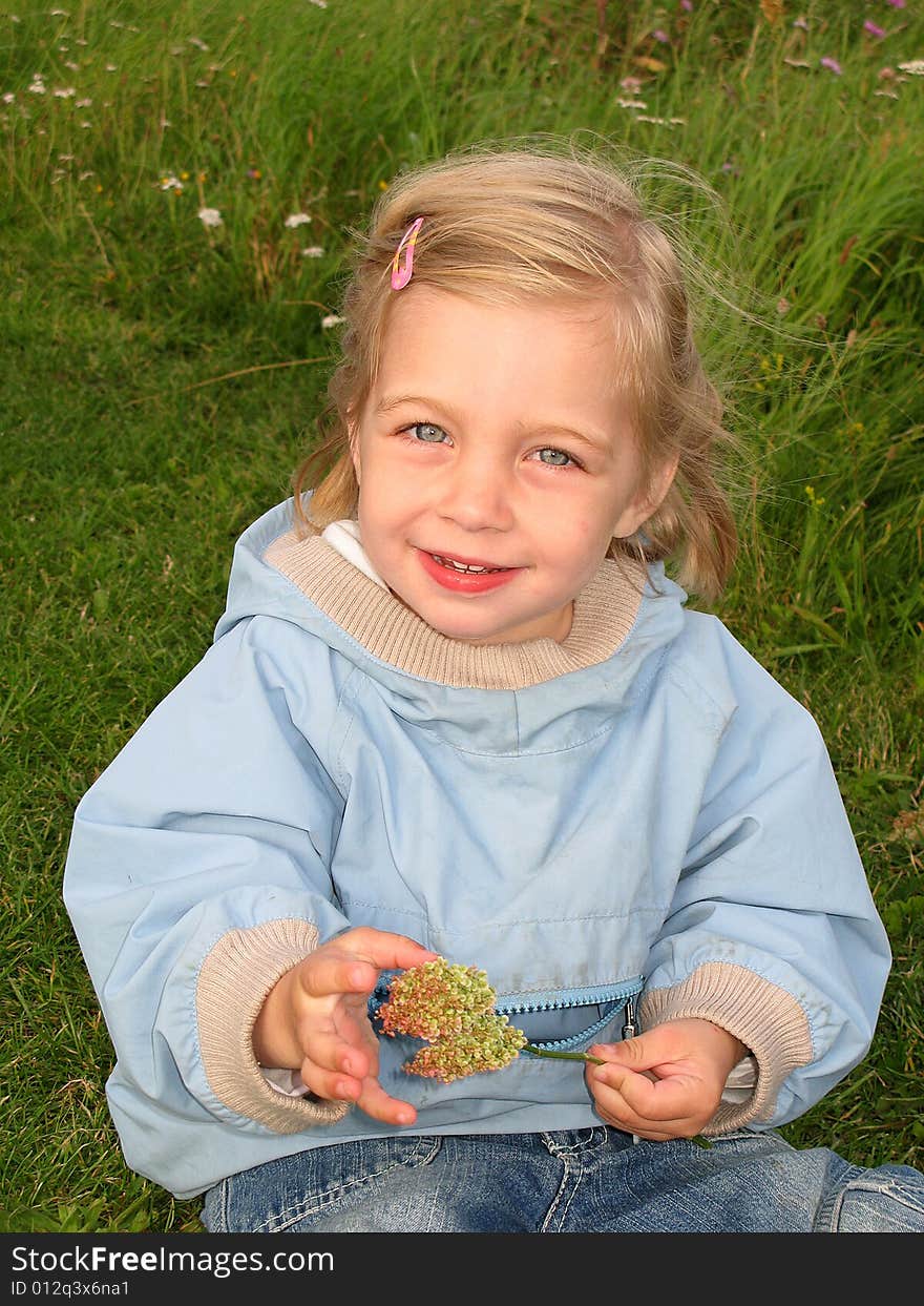 A beautiful 2-year old girl with a flower. A beautiful 2-year old girl with a flower