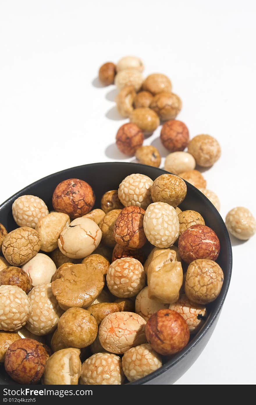 Bowl of Asian rice and sesame crackers against white background. Bowl of Asian rice and sesame crackers against white background