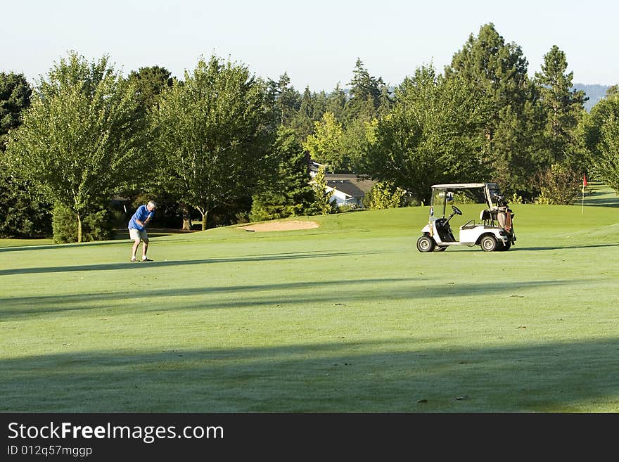 Elderly Man Swinging On Course