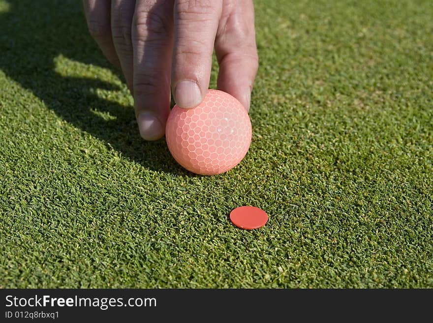 Man Putting Ball on Marker - Horizontal