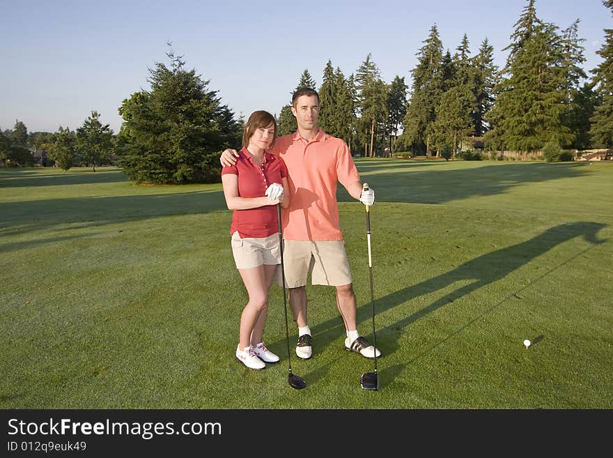 Couple playing golf. Horizontally framed shot. Couple playing golf. Horizontally framed shot.